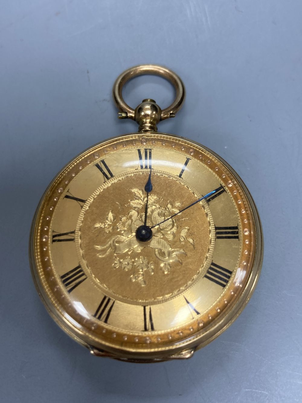 An early 20th century engine turned 18k and enamel(a.f.) keywind fob watch, case diameter 35mm, gross 29.2 grams.